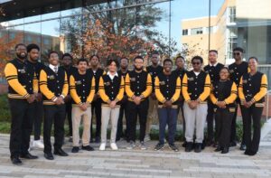 a group of young undergraduate students lined up proudly